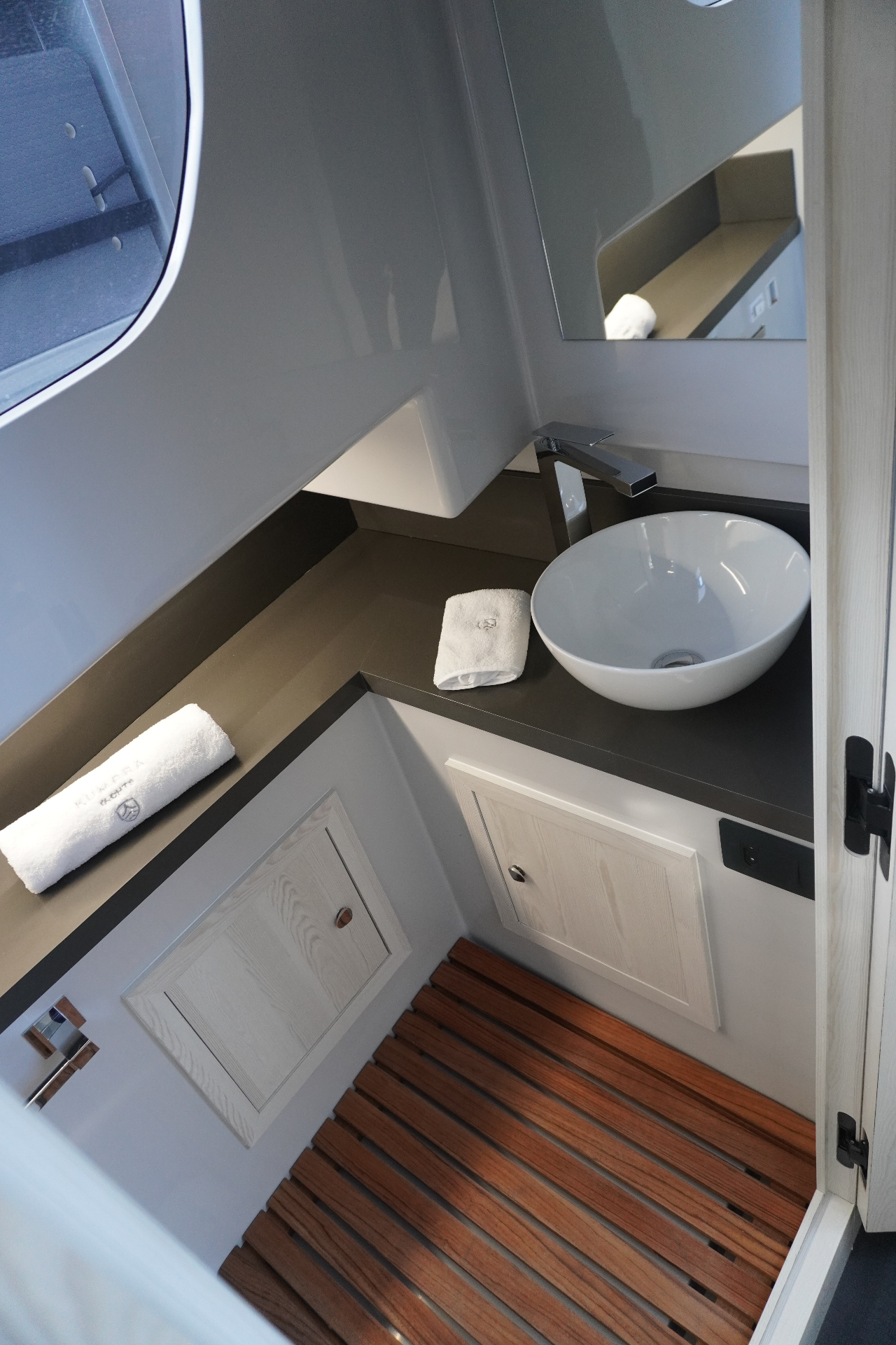 Bathroom with sink, shower and ventilation.