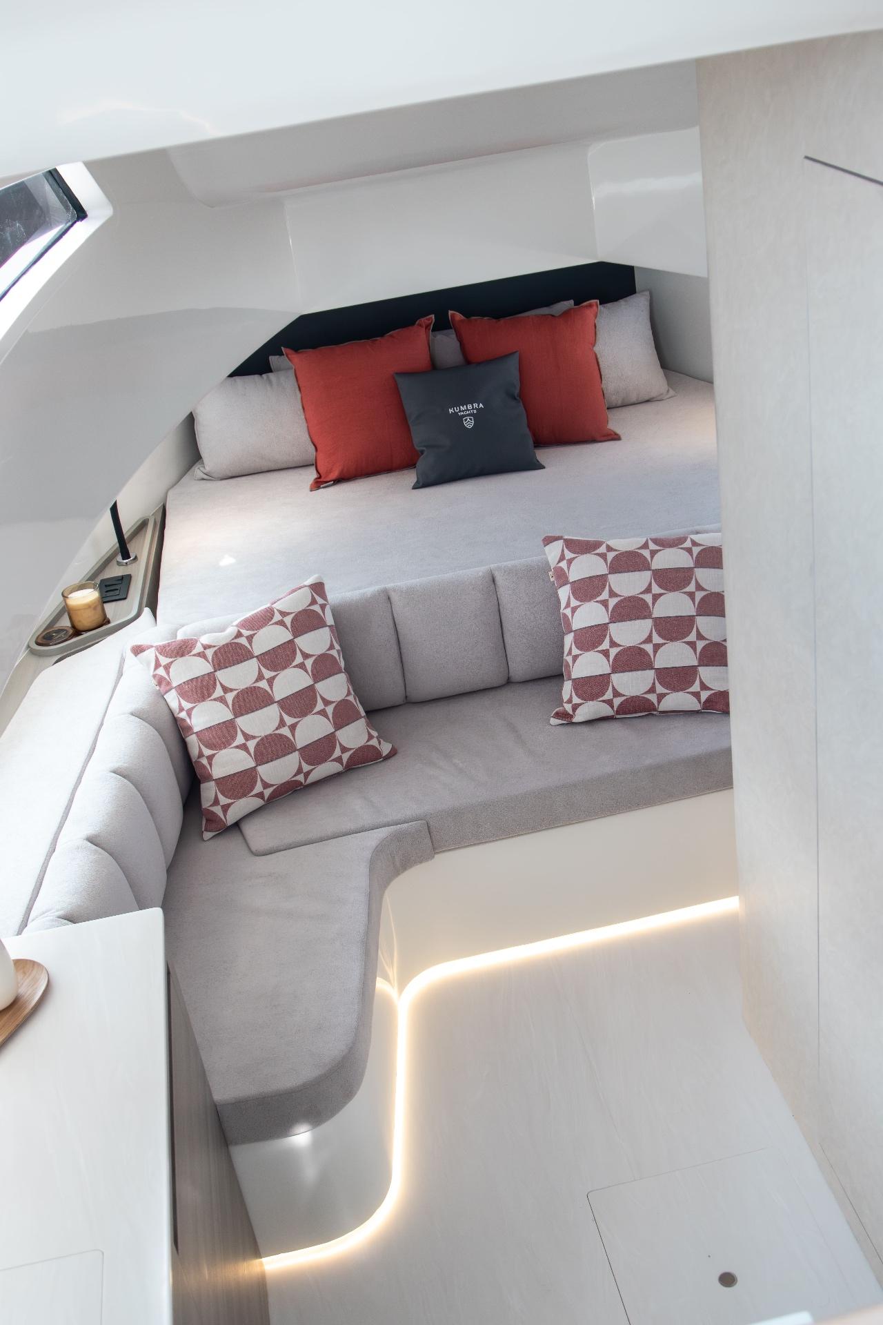 Master cabin with double bed and ambient LED lighting.